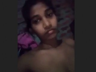 A youthful girl indulging in self-pleasure