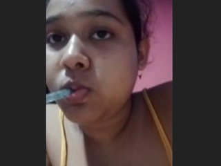 An Indian woman seductively pleases her partner in a sensual recording