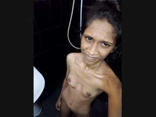 A thin Sri Lankan girl with small breasts bathes