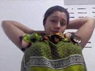 Aroused mature woman with large breasts displays herself