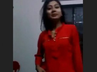 Young woman removes her outfit and pleasures herself