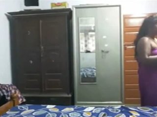 A seductive spouse engages in intimate activities with her paramour within the confines of their bedroom