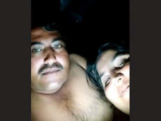 A mature couple shares a romantic evening in the countryside