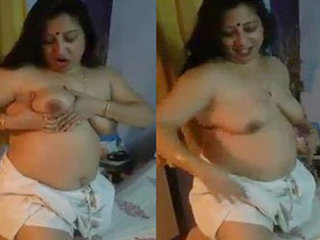 An Indian housewife prepares for a sexual encounter while engaging in vulgar conversation in Bengali