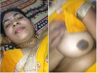 Busty bhabhi's seductive pose with her boobs