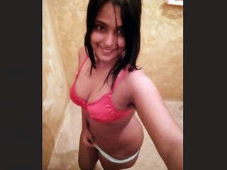 Young woman pleasures herself with her big boobs in video